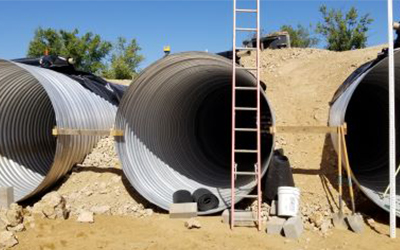 Large metal cylinders covered in dirt