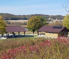 Far away photo of the restroom building. Solar panels are visible on the roof.