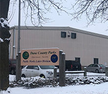 Entrance sign with building in background
