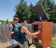 People purchasing a permit from a paystation