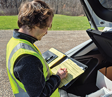 staff with clipboard writing down data